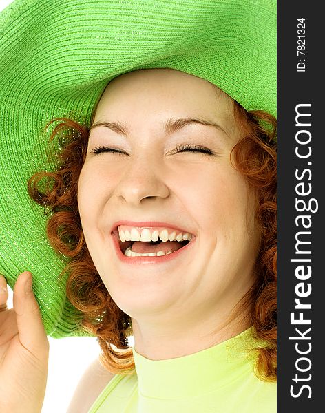 Portrait of a happy young laughing woman wearing a green beach hat. Portrait of a happy young laughing woman wearing a green beach hat