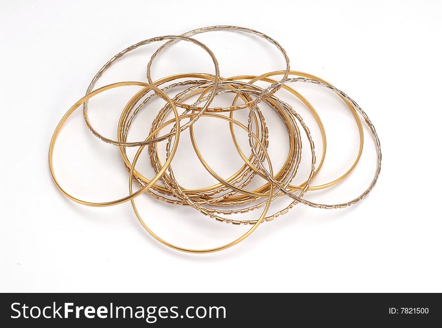 Gold bracelets isolated at white