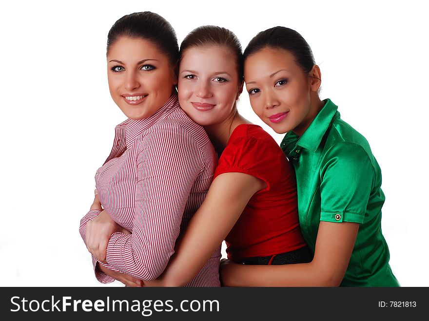 Three beautiful happy young friends embrace one another. Three beautiful happy young friends embrace one another