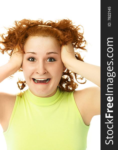 Portrait of a young ginger frustrated woman tearing her hair and shouting