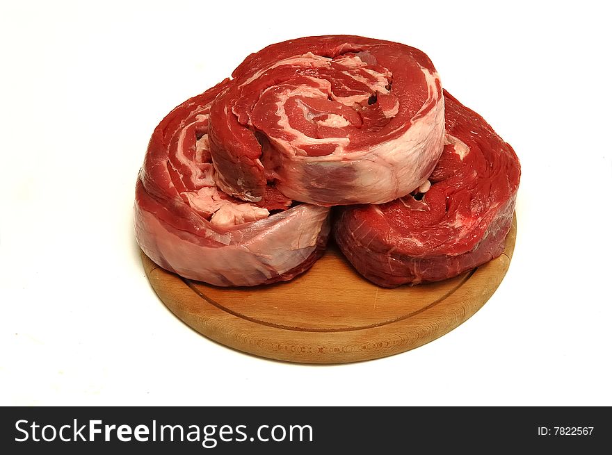 Meat pieces on wooden plate