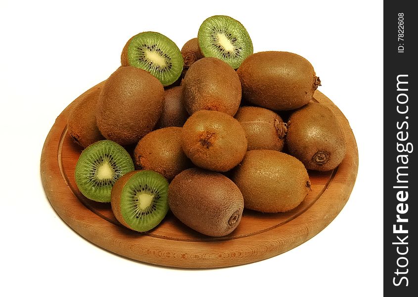 Several kiwis on wooden plate