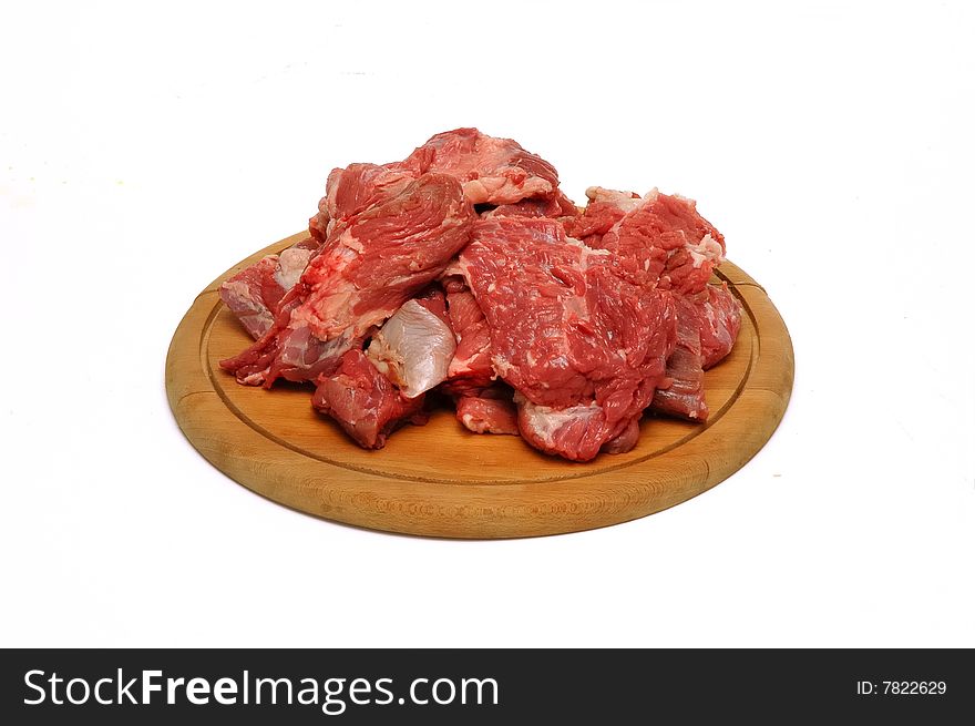 Meat pieces on wood plate