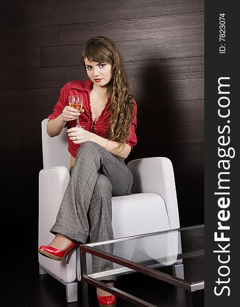 Blonde dressed up in red holding a wineglass. Blonde dressed up in red holding a wineglass