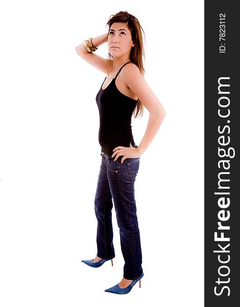 Side view of young woman looking up against white background