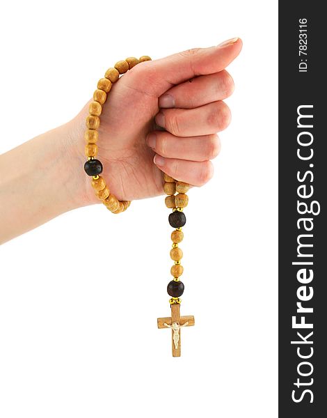 Female hand holds wooden rosary isolated on a white background