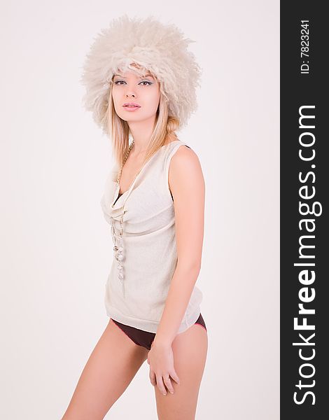 Romantic girl in furry hat, studio shot
