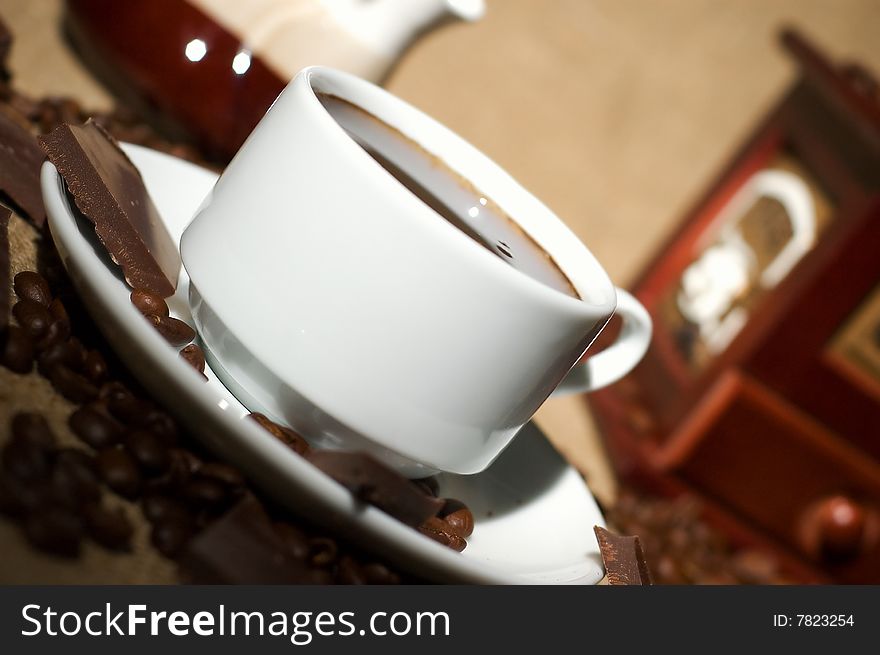 Still life with cup of coffee and coffee-mill on the sack