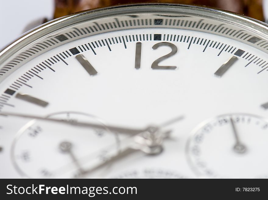 Close-up photo of a wrist watch with copyspace and focus on 12 sign. Close-up photo of a wrist watch with copyspace and focus on 12 sign