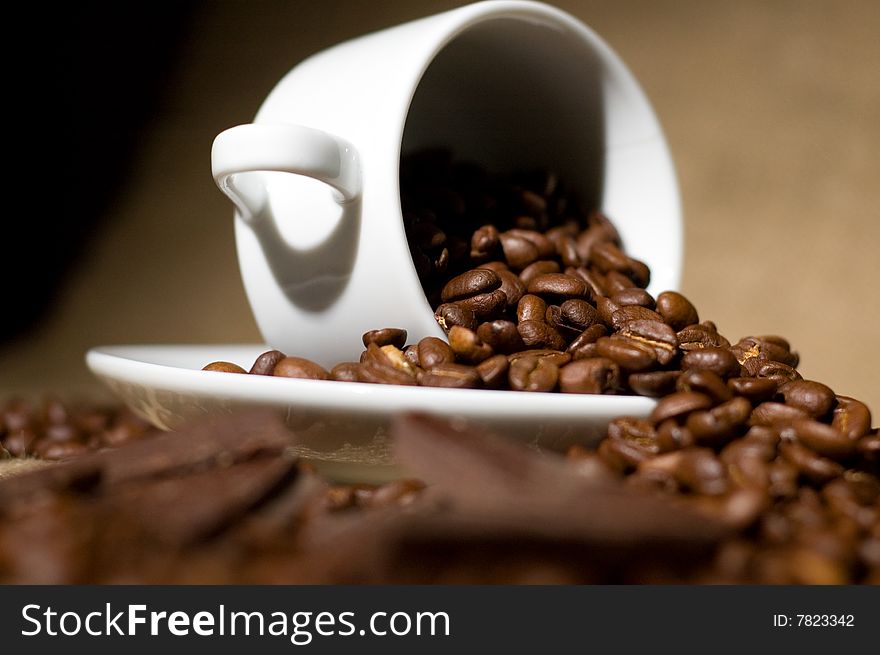 Still life with cup of coffee and coffee-beans on the sackcloth