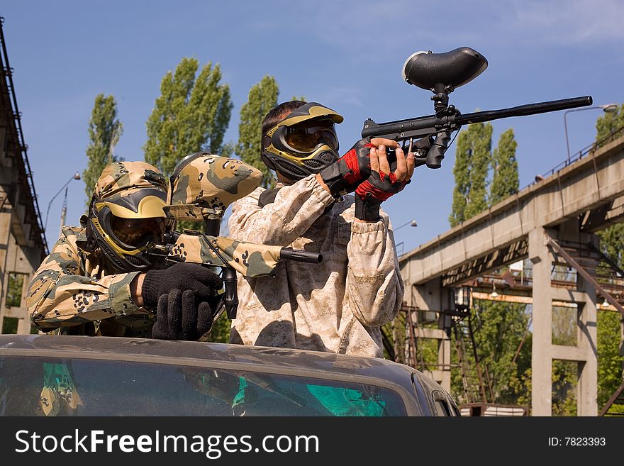 Paintball players on the car