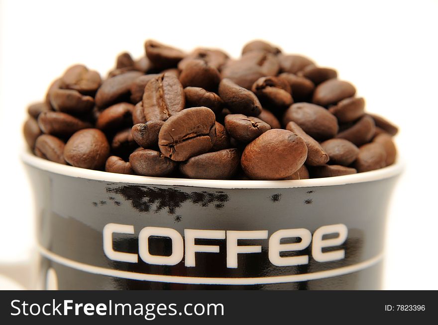 Coffee beans in the glass on white background