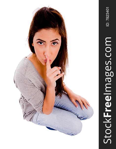 Top view of young woman instructing to be silent against white background. Top view of young woman instructing to be silent against white background