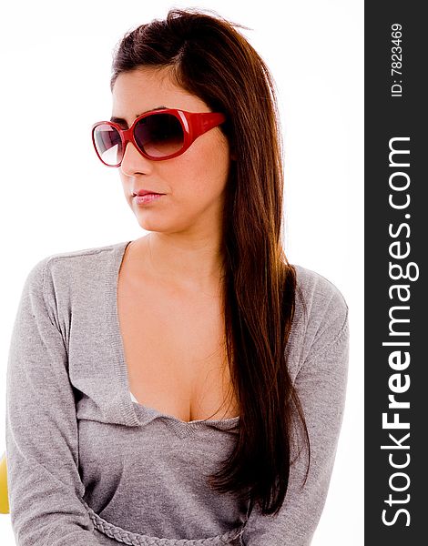 Portrait of young woman wearing sunglasses on an isolated white background