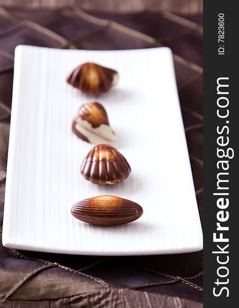 Four assorted chocolates laid out on a plate. Four assorted chocolates laid out on a plate