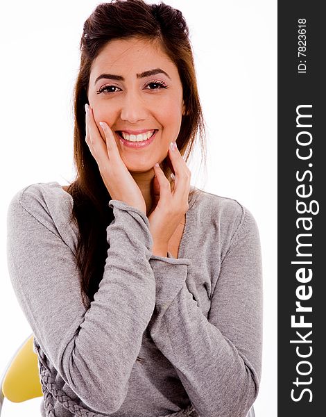 Portrait of smiling young woman holding her face with white background