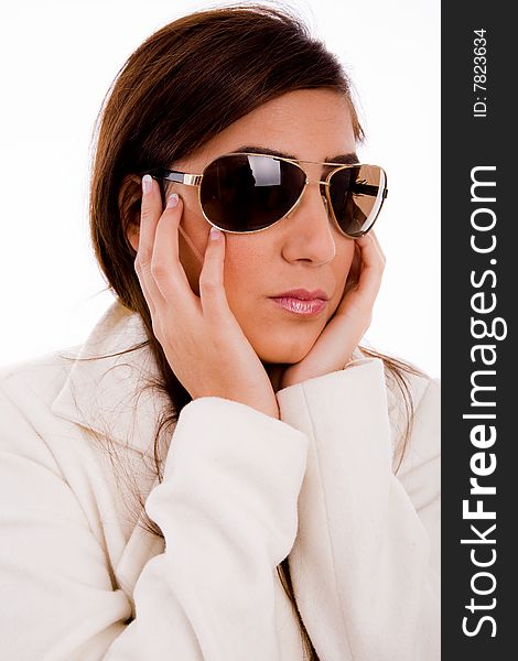 Portrait of young female wearing sunglasses against white background. Portrait of young female wearing sunglasses against white background