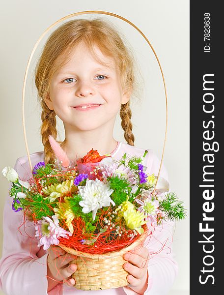 Small girl with a basket of flowers