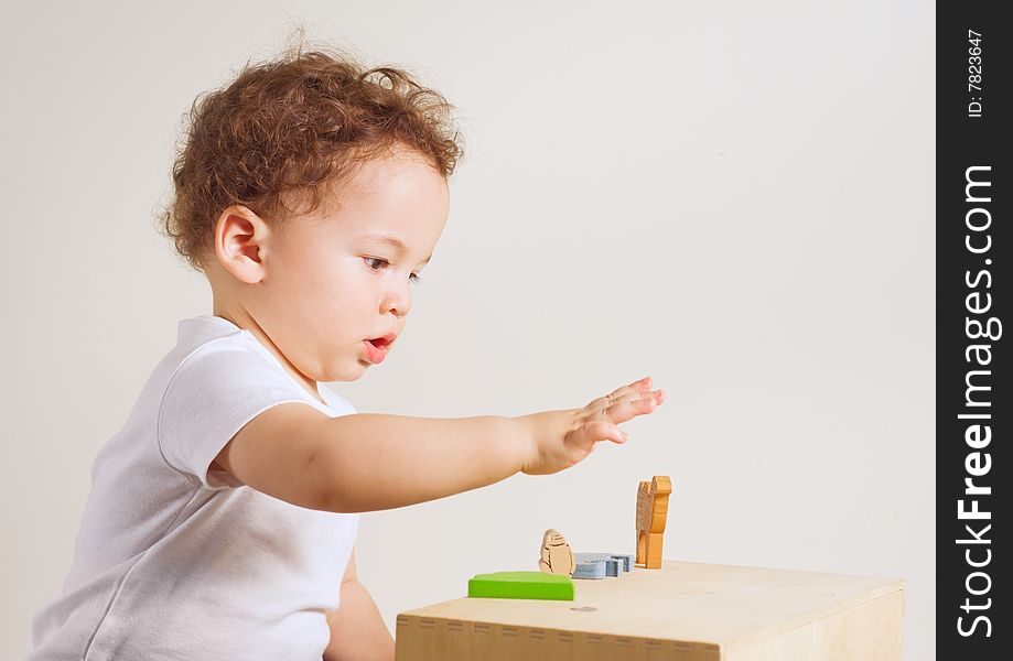 Small boy playing with colorful toys