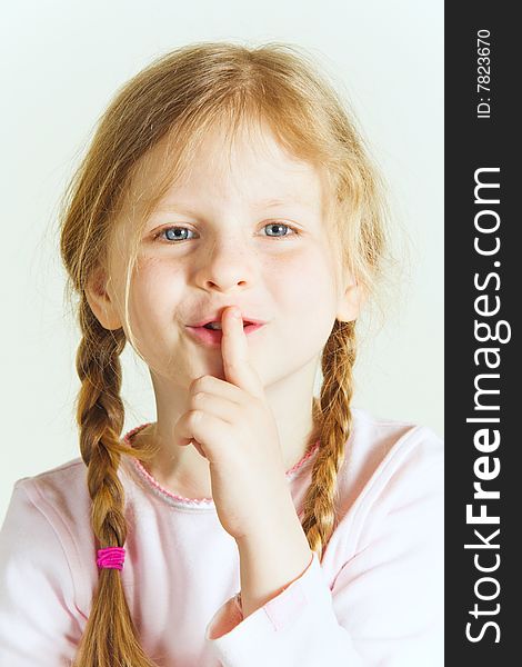 Small girl with a finger at her mouth