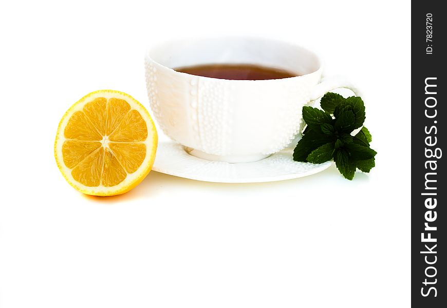 Isolated white tea cup with lemon and mint. Isolated white tea cup with lemon and mint