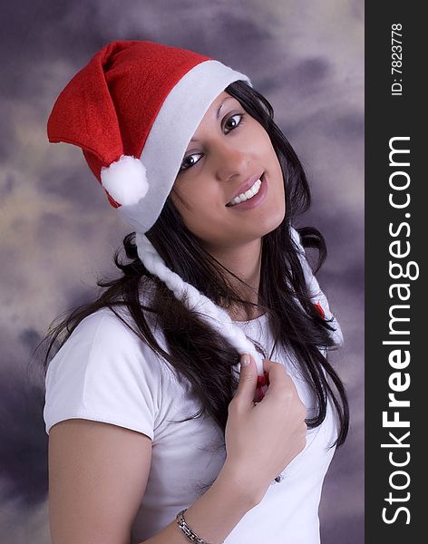 Young women put santas cap on here head. Young women put santas cap on here head