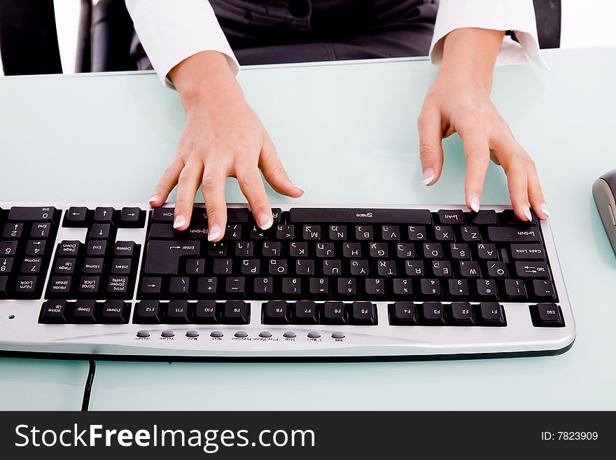 Close view of hands operating keyboard on an isolated white background. Close view of hands operating keyboard on an isolated white background