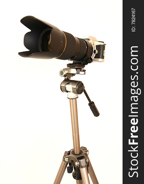 Professional tele lens on the tripod isolated on white. Professional tele lens on the tripod isolated on white.