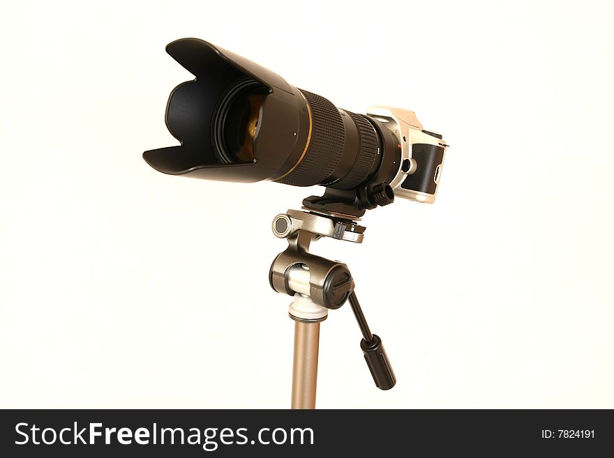 Professional tele lens on the tripod isolated on white. Professional tele lens on the tripod isolated on white.