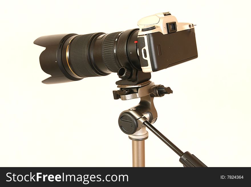 Professional tele lens on the tripod isolated on white. Professional tele lens on the tripod isolated on white.