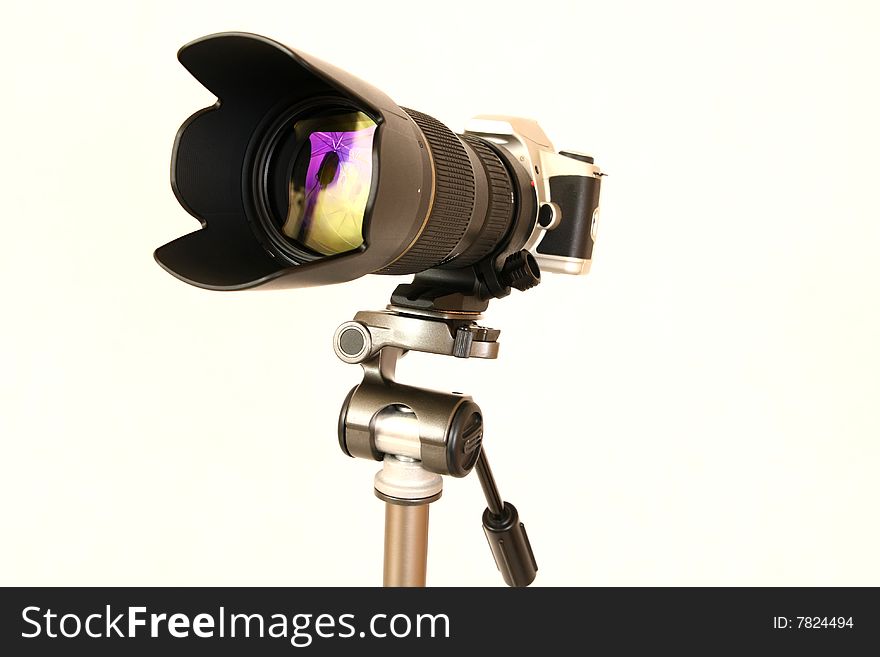 Professional tele lens on the tripod isolated on white. Professional tele lens on the tripod isolated on white.