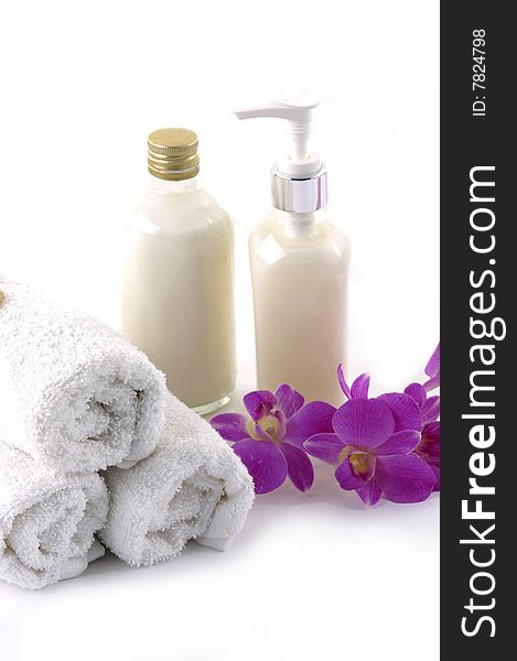 Towels, orchid and bath lotion on the white background. Towels, orchid and bath lotion on the white background