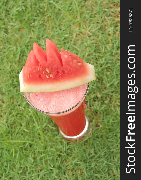 Fresh watermelon juice on grass