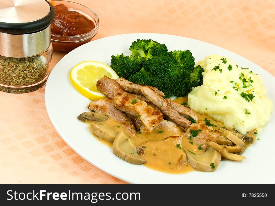 A Grilled Top Sirloin Steak Of Pork.. Chopped,with Broccoli And Fresh Mashed Potatoes.