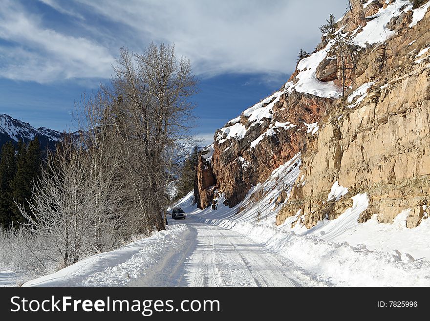 Car driving down snowy mountain road in Wyoming, USA. Car driving down snowy mountain road in Wyoming, USA