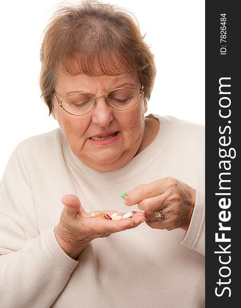 Attractive Senior Woman and Pills Isolated on a White Background.