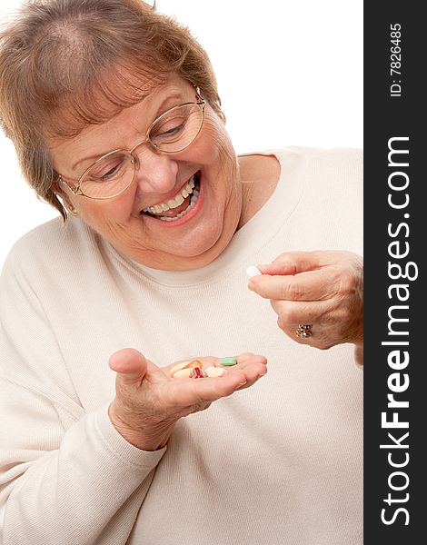 Attractive Senior Woman and Pills Isolated on a White Background.