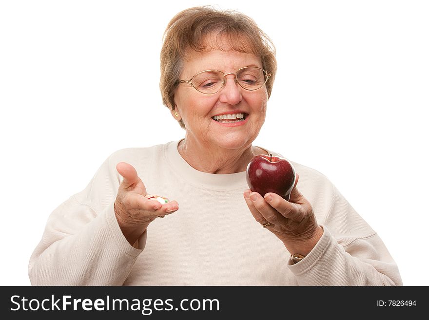 Happy Attractive Senior Woman Holding Apple and Vitamins Isolated on a White Background.