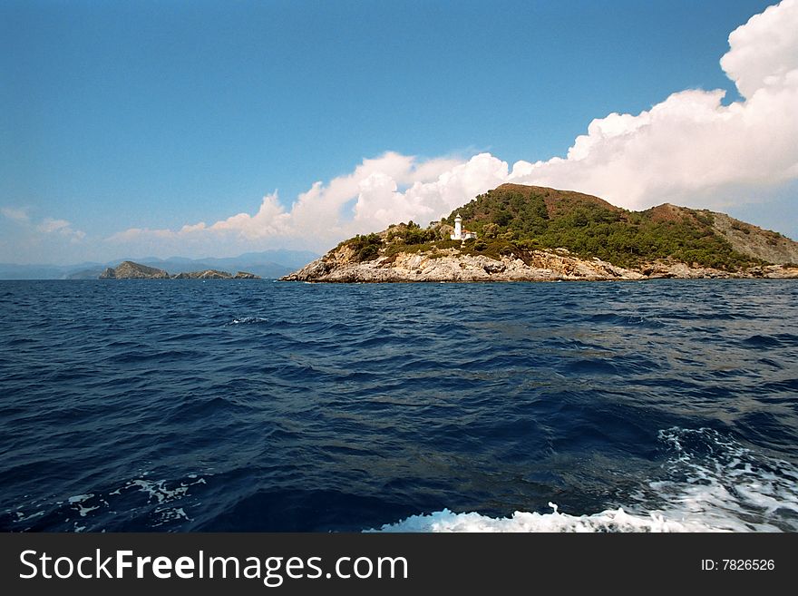 Lighthouse on island at the entrance to Fithie harbour in Turkey