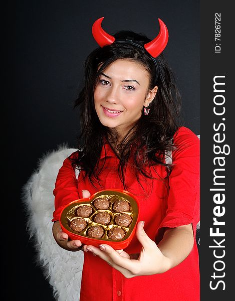 Valentine Girl offering chocolates from a heart shape box.