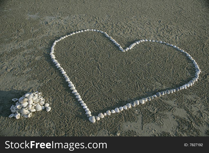 An image of heart made from seashells on the beach. An image of heart made from seashells on the beach