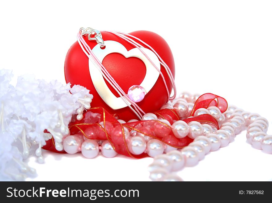 Valentine hearts,red ribbon,pink pearls and fabric flowers on white background.