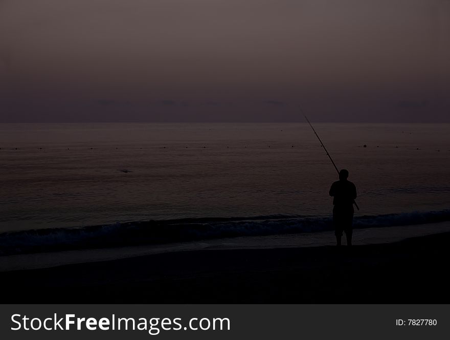 Night shot of fisherman on beach