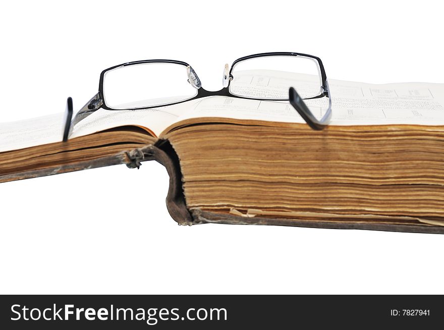 Old large book with glasses