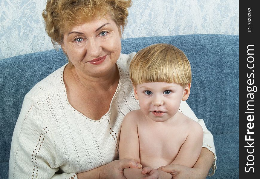 Portrait of the grandmother with the grandson in house conditions