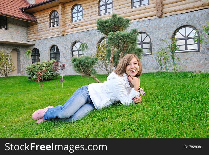 Smiling girl lie on grass