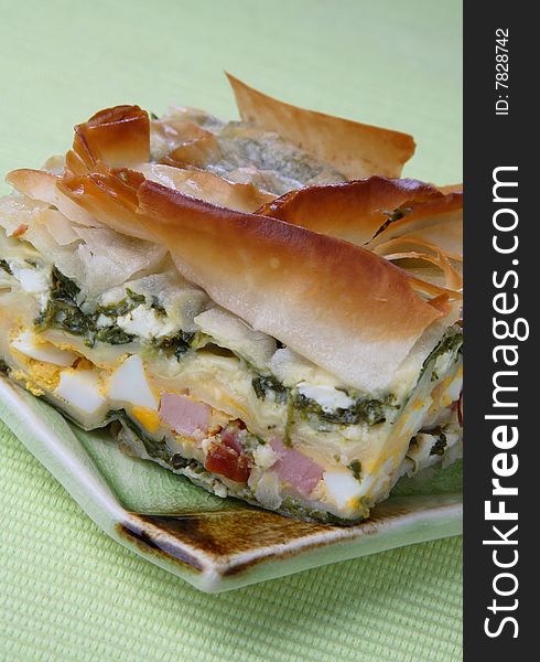 Baked pie with ham, spinach and boiled eggs