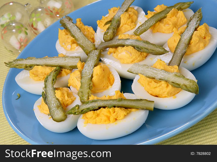 Boiled eggs with asparagus on plate