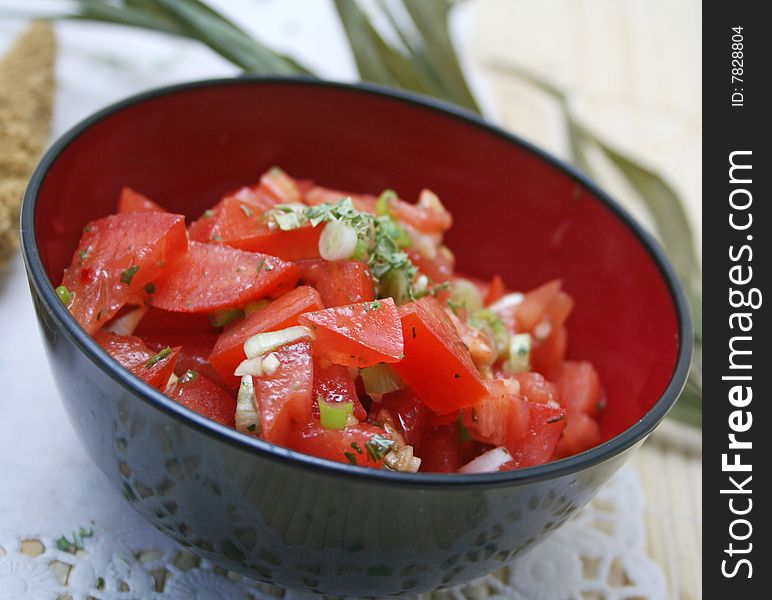 A fresh salad of tomatoes with onions and spices