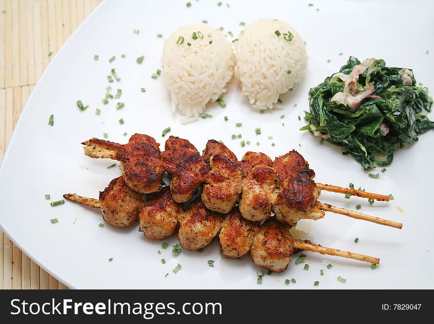 A meal of meat, fresh spinach and rice. A meal of meat, fresh spinach and rice